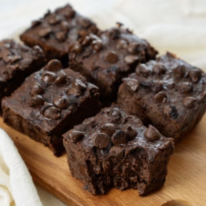 Fudgy black bean brownies with chocolate chips on a wooden board